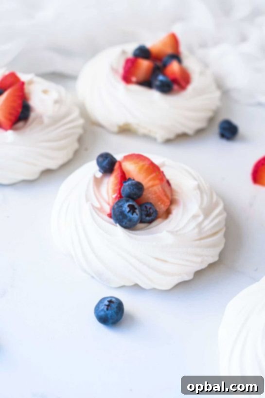 22 Firecracker Flavors for the Fourth 11 Fruity and fabulous Red, White and Blue Pavlovas recipe, guaranteed to impress as a stunning dessert for the 4th of July celebration.