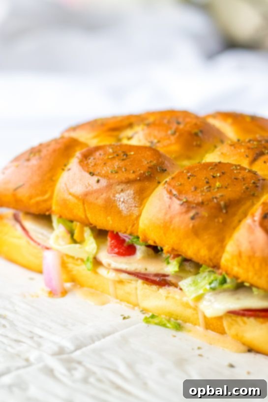 Zesty Italian Sliders 7 Baked Italian Sub Sliders fresh out of the oven, cheese melted and rolls golden, ready to be topped