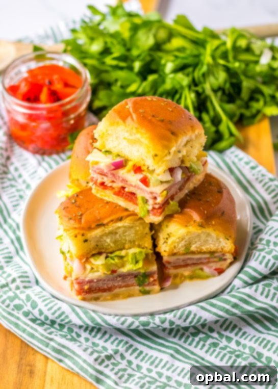 Zesty Italian Sliders 9 Overhead shot of a platter of Italian Sub Sliders, showcasing the full presentation with fresh toppings