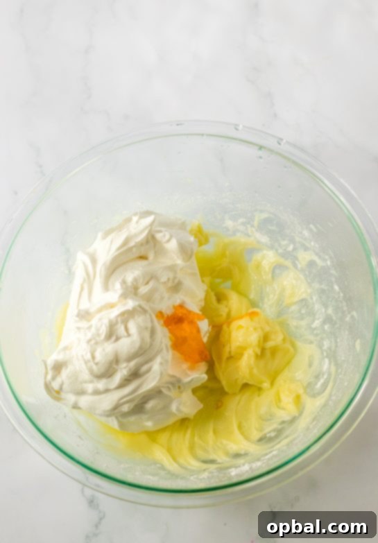 Decadent Candy Corn Delight 4 Mixing the ingredients needed to make the candy corn lush for fall dessert recipe