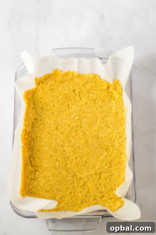 Decadent Candy Corn Delight 5 Pressing in the Oreo cookie crust needed to make the candy corn lush for fall dessert recipe