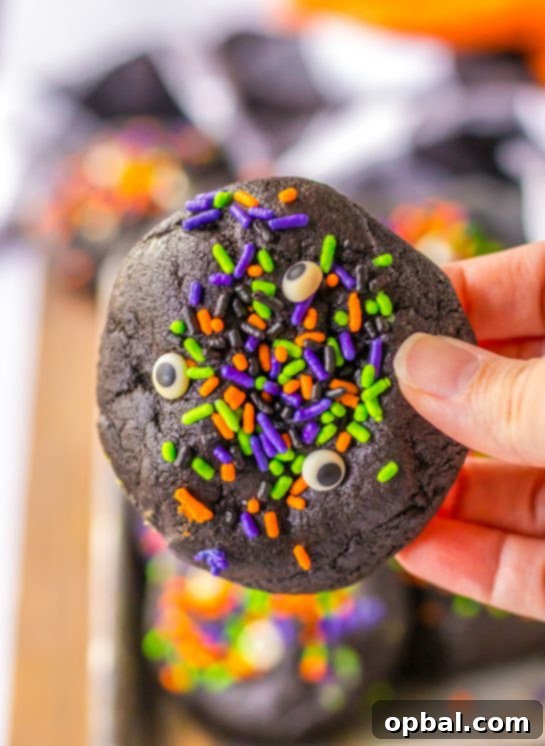 Midnight Velvet Stuffed Cookies 6 Close-up of a Stuffed Black Velvet Cookie, showing the rich dark chocolate and cheerful Halloween sprinkles.