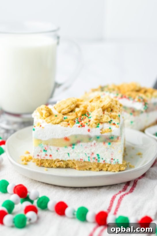 Yuletide Cookie Bliss 2 A festive no-bake Christmas Cookie Lush dessert, showcasing its delightful layers of vanilla cream cookies, creamy cheesecake, smooth pudding, and whipped topping, adorned with colorful sprinkles and crushed cookies.