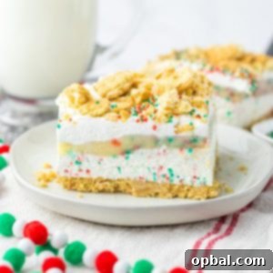 Yuletide Cookie Bliss 13 Christmas Cookie Lush is the perfect holiday dessert. This is no-bake, so it makes for a quick dessert when you are entertaining. Layers of vanilla cream cookies and sprinkles, a cheesecake layer, finished off with a pudding layer, whipped topping, crushed cookies and sprinkles to look like the perfect Christmas Cookie dessert.