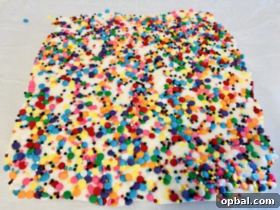 Vanilla Sugar Cookie Fudge 4 Prepared ingredients for creamy no-bake Sugar Cookie Fudge, mixed and ready to be set, ideal for a festive holiday dessert.