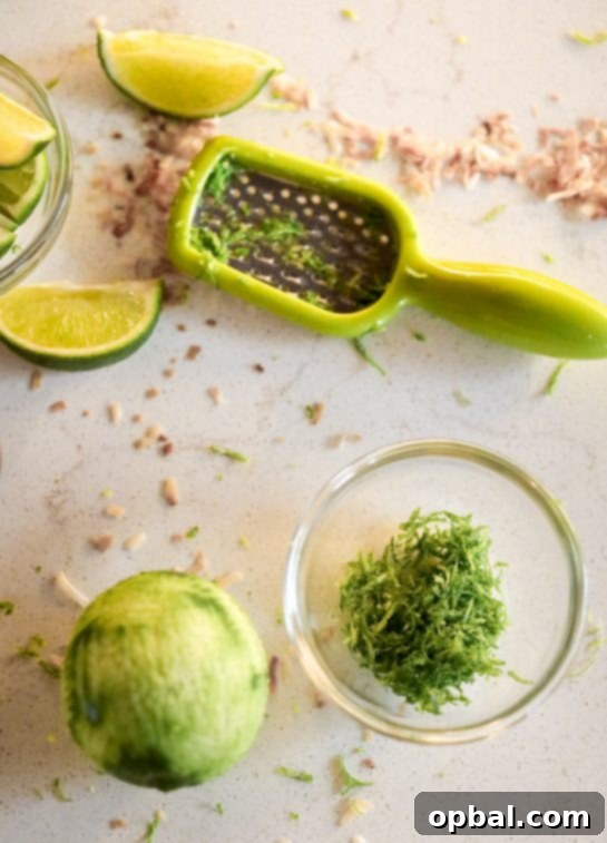 Zesty Coconut Lime Margarita Oasis 4 Close-up of fresh lime being zested for the Coconut Lime Frozen Margaritas recipe.