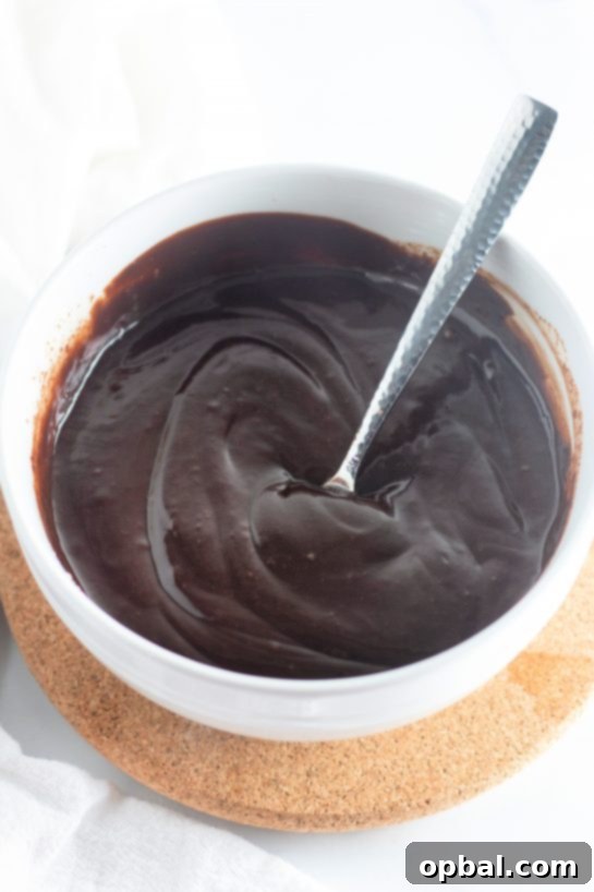Starlight Sprinkled Brownie Pie 4 Hands mixing wet and dry ingredients in a bowl, a crucial step in preparing the rich and fudgy batter for the Cosmic Brownie Pie recipe.