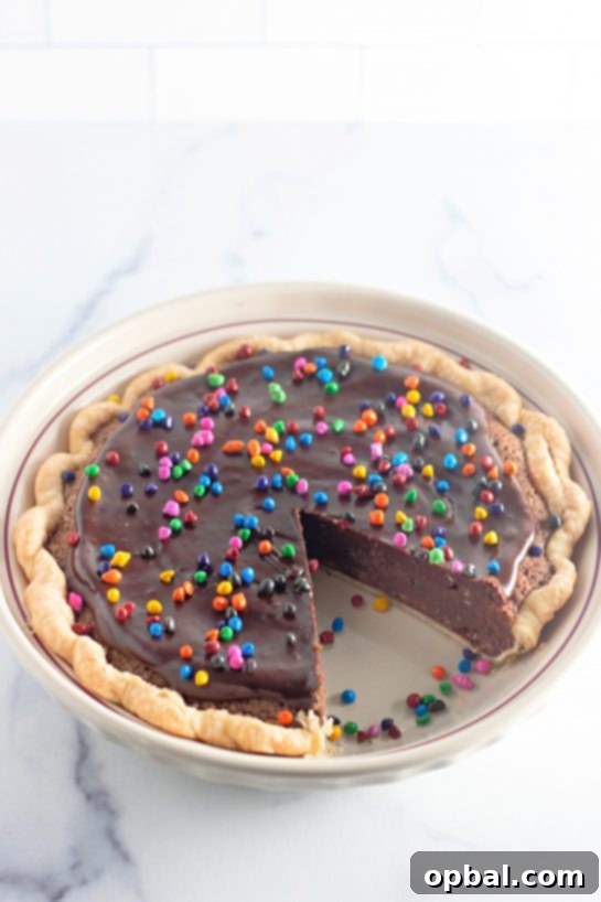 Starlight Sprinkled Brownie Pie 9 A glorious shot of the Cosmic Brownie Pie with a slice elegantly removed, highlighting the perfect texture of the fudgy brownie interior.