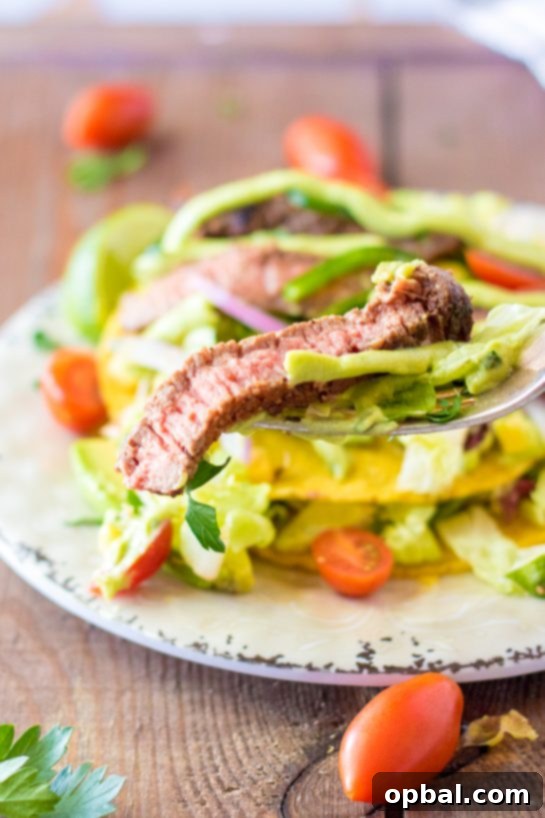 Southwestern Steak Tostada Salad 6 Sliced steak arranged beautifully on a Steak Tostada Salad