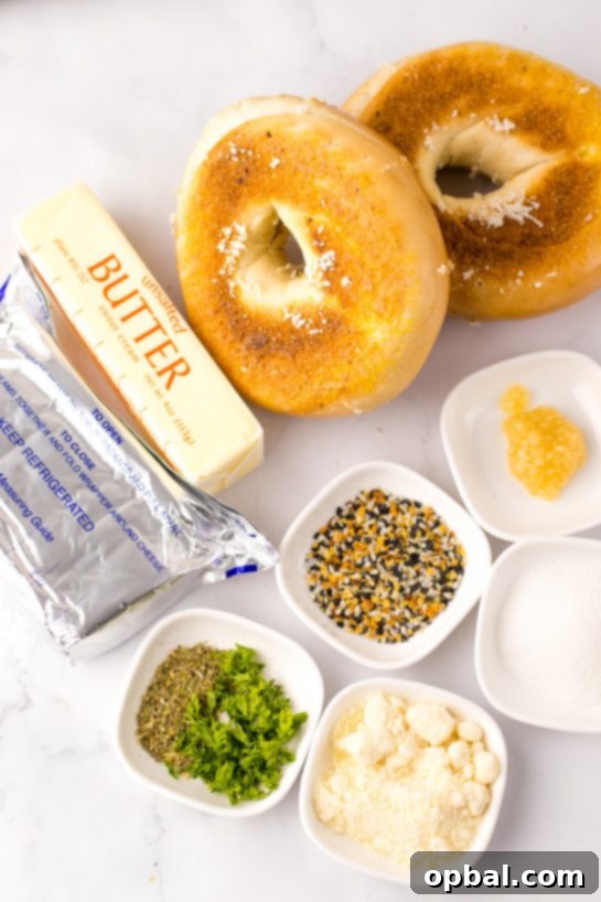 Ingredients needed to make the viral Tik Tok Stuffed Bagels recipe including bagels, cream cheese, butter, garlic, herbs, and seasonings.