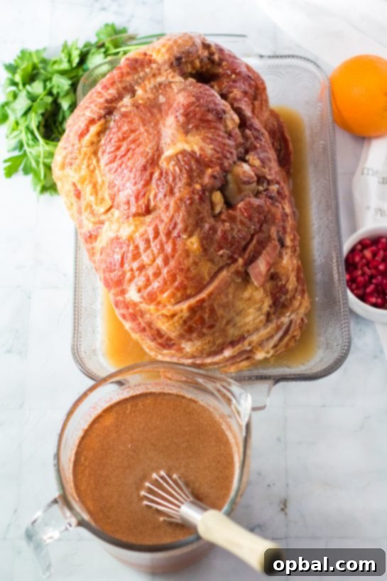 Christmas Glazed Ham 4 Preparing the vibrant orange, honey, and brown sugar glaze for the Christmas ham recipe, a crucial step for a rich flavor.