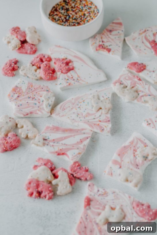 Festive No-Bake Animal Cracker Bark 3 Irresistible No-Bake Circus Cookie Bark, a playful dessert with circus animal cookies, white chocolate, and pink drizzle.