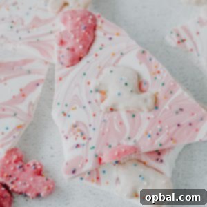 No-Bake Circus Cookie Bark dessert recipe with colorful cookies, white chocolate, and sprinkles.