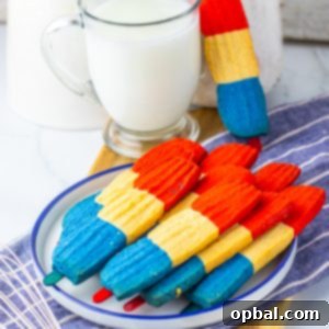 This recipe for Bomb Pop Cookies is not only so tasty but so cute for the 4th of July! These are the perfect dessert to bring for those red, white and blue holidays. Bursting with Sugar cookie flavors with hints of cherry flavoring in the red and blueberry flavoring in the blue, using Jello! These were so fun to make and were a huge hit for everybody involved!