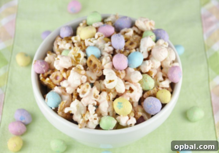 A bowl overflowing with vibrant Salted Caramel Easter Popcorn, garnished with an array of colorful peanut M&Ms, ready for snacking.