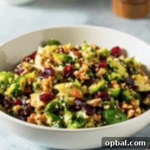 Brussels Sprouts Cranberry Walnut Salad Recipe – A vibrant and healthy salad featuring shredded Brussels sprouts, tangy dried cranberries, and crunchy walnuts.