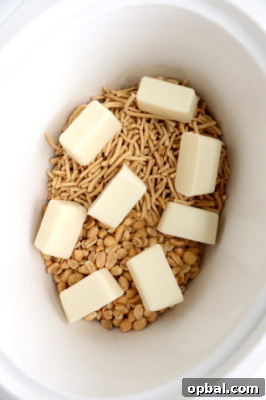 Melting the butter for this fun, festive, and easy White Chocolate Halloween Crock Pot Candy Recipe