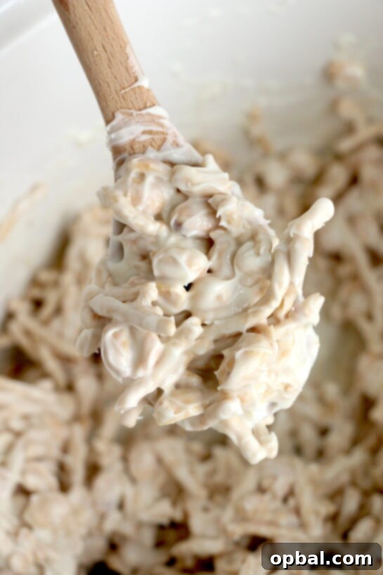 Close-up photo in the crock pot of this fun, festive, and easy White Chocolate Halloween Crock Pot Candy Recipe