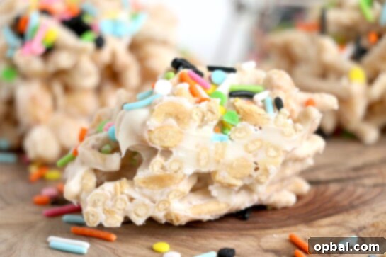 Close-up photo of the easy White Chocolate Halloween Crock Pot Candy made with crunchy chow mein noodles, creamy white chocolate bark, and colorful Halloween sprinkles.