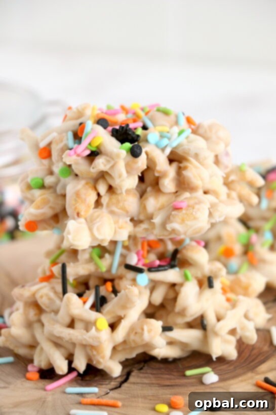 Get ready for Halloween with this fun, festive, and easy White Chocolate Halloween Crock Pot Candy made with crunchy chow mein noodles, creamy white chocolate bark, and colorful Halloween sprinkles. These no-bake Halloween treats are the perfect last-minute party snack or spooky holiday dessert made right in the crock pot that all ages will love.