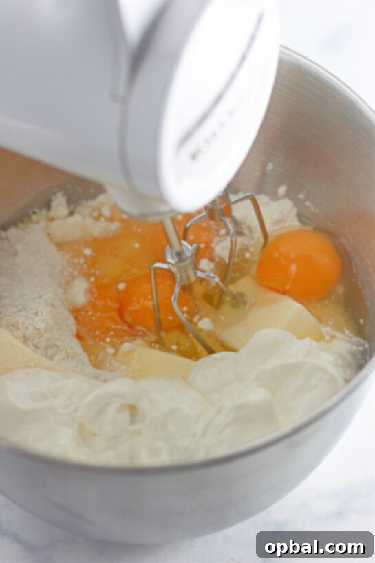 Glazed Honey Swirl Cake 4 Mixing the ingredients needed to make the Honey Bun Cake recipe for the holidays