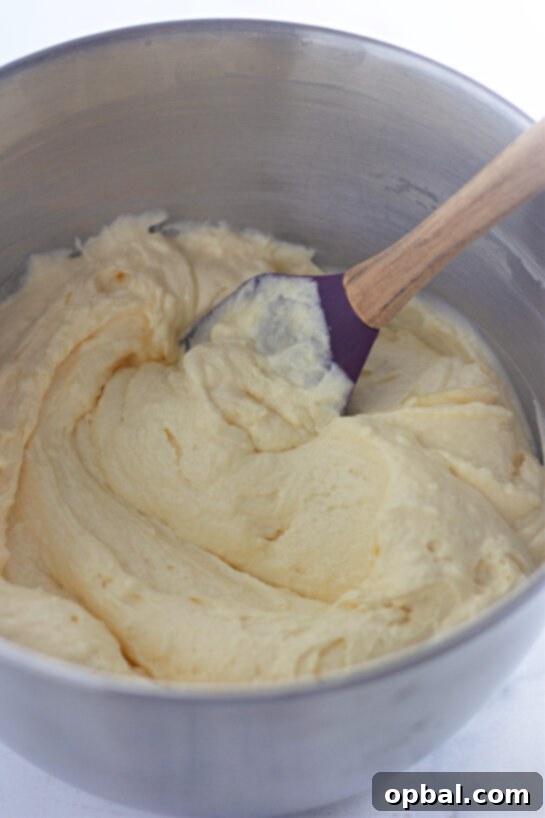 Glazed Honey Swirl Cake 6 Mixing the frosting to make the Honey Bun Cake recipe for the holidays