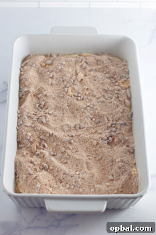 Glazed Honey Swirl Cake 8 Adding the pecan topping to make the Honey Bun Cake recipe for the holidays
