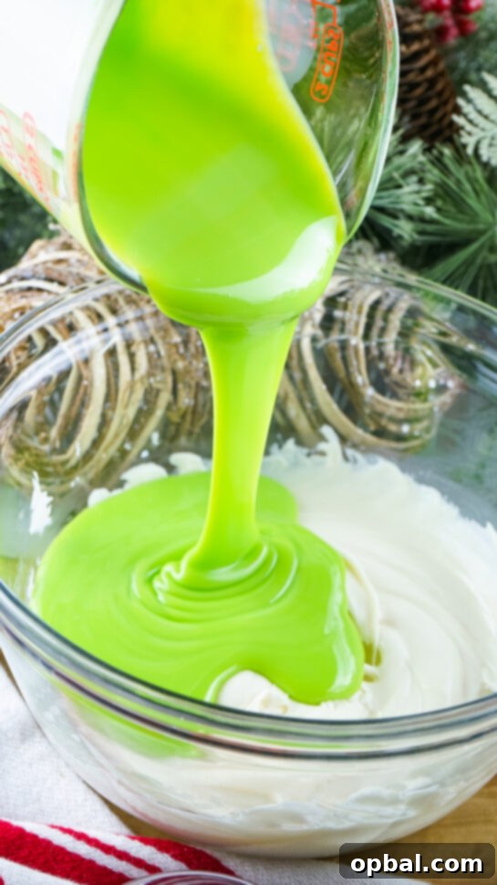 Pouring the Grinch Fudge mixture into a pan, ready to chill.