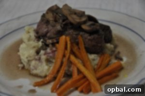Perfectly seared beef tenderloin with a rich mushroom pan sauce, garnished with fresh herbs, ready for a romantic dinner.