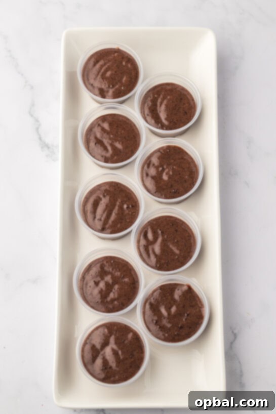 Hot Chocolate Pudding Shooters 6 Pouring the Bailey's mixture into shot glasses